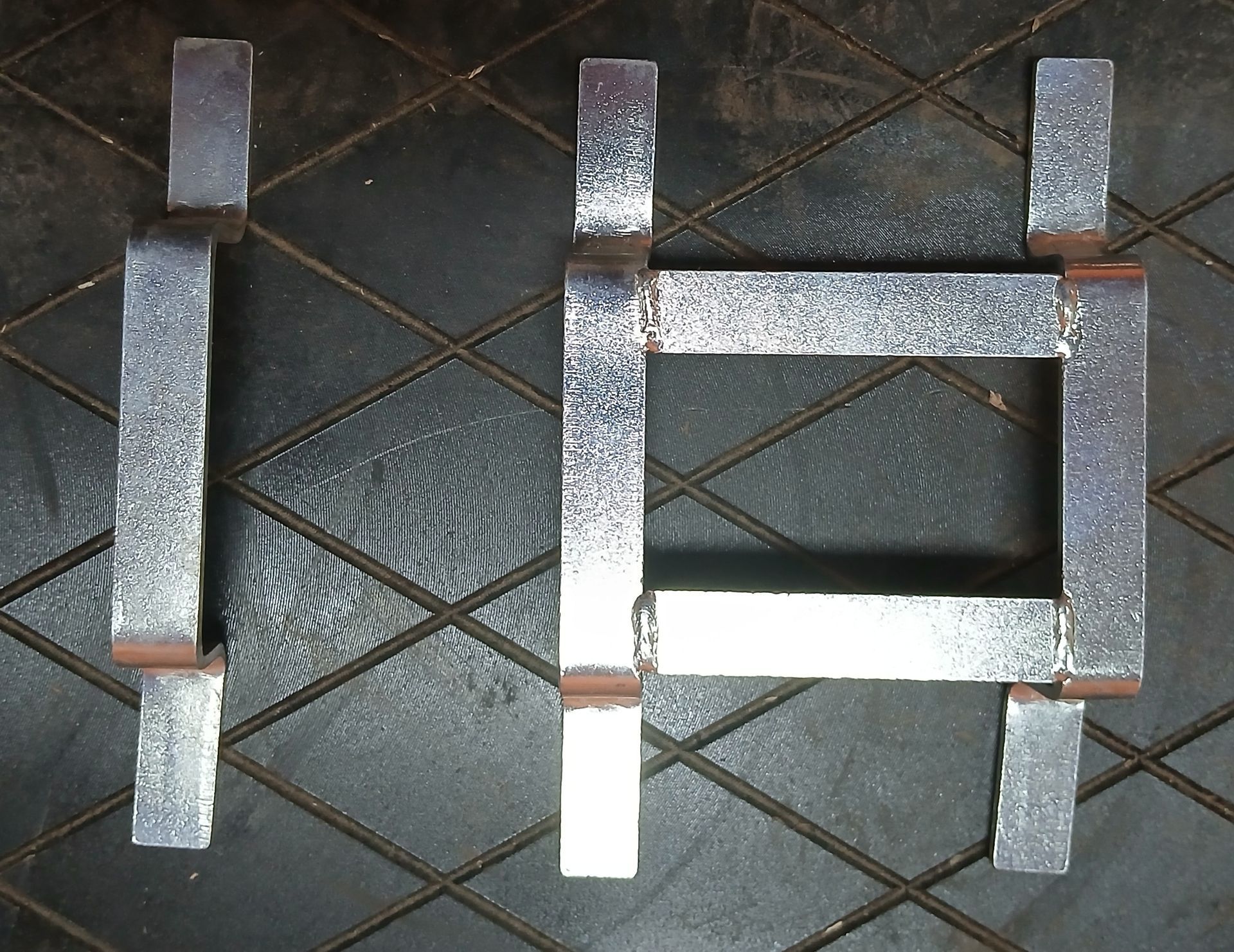 Three metal pieces arranged in an 