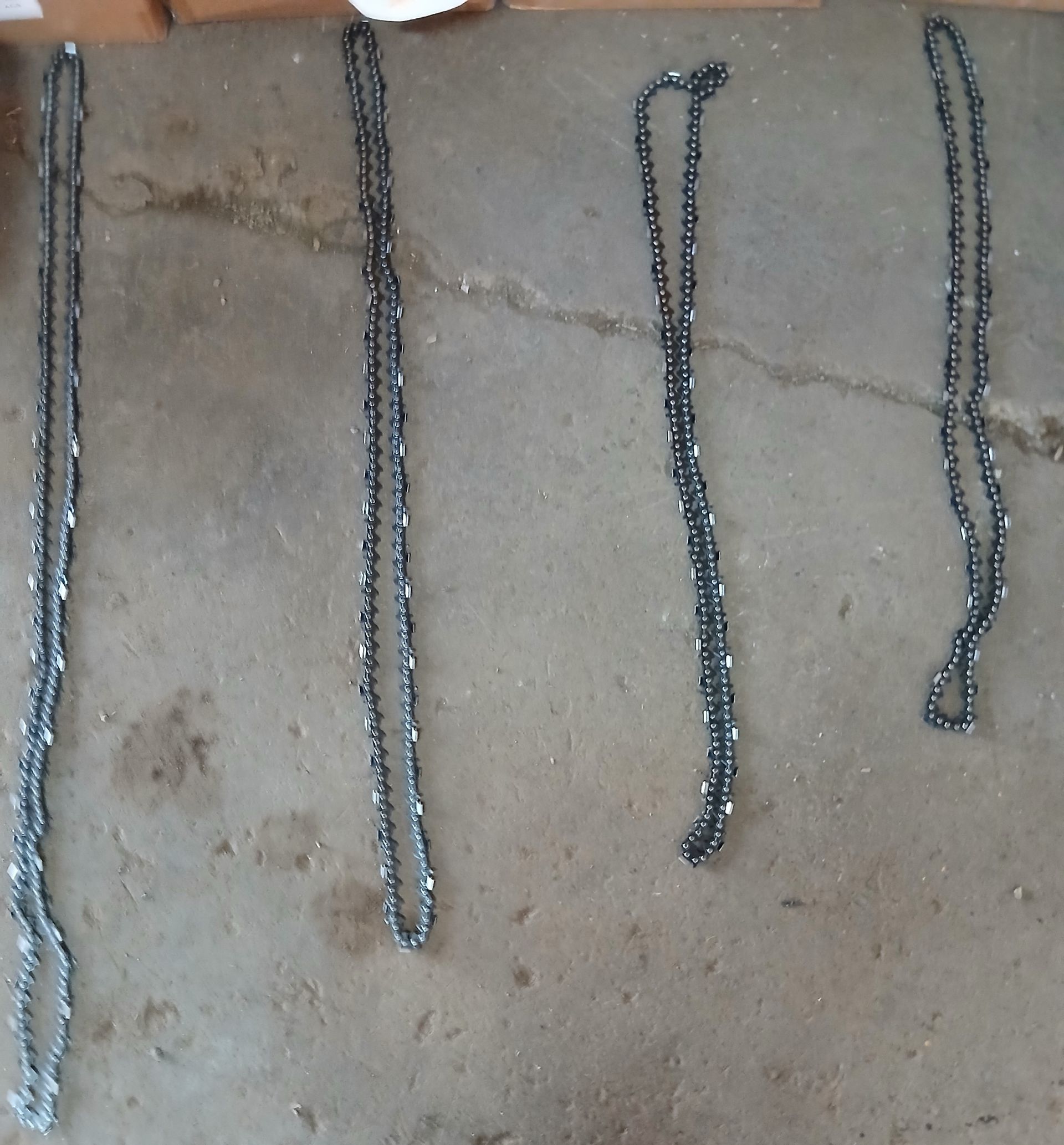 A person is sharpening a chainsaw on a machine.