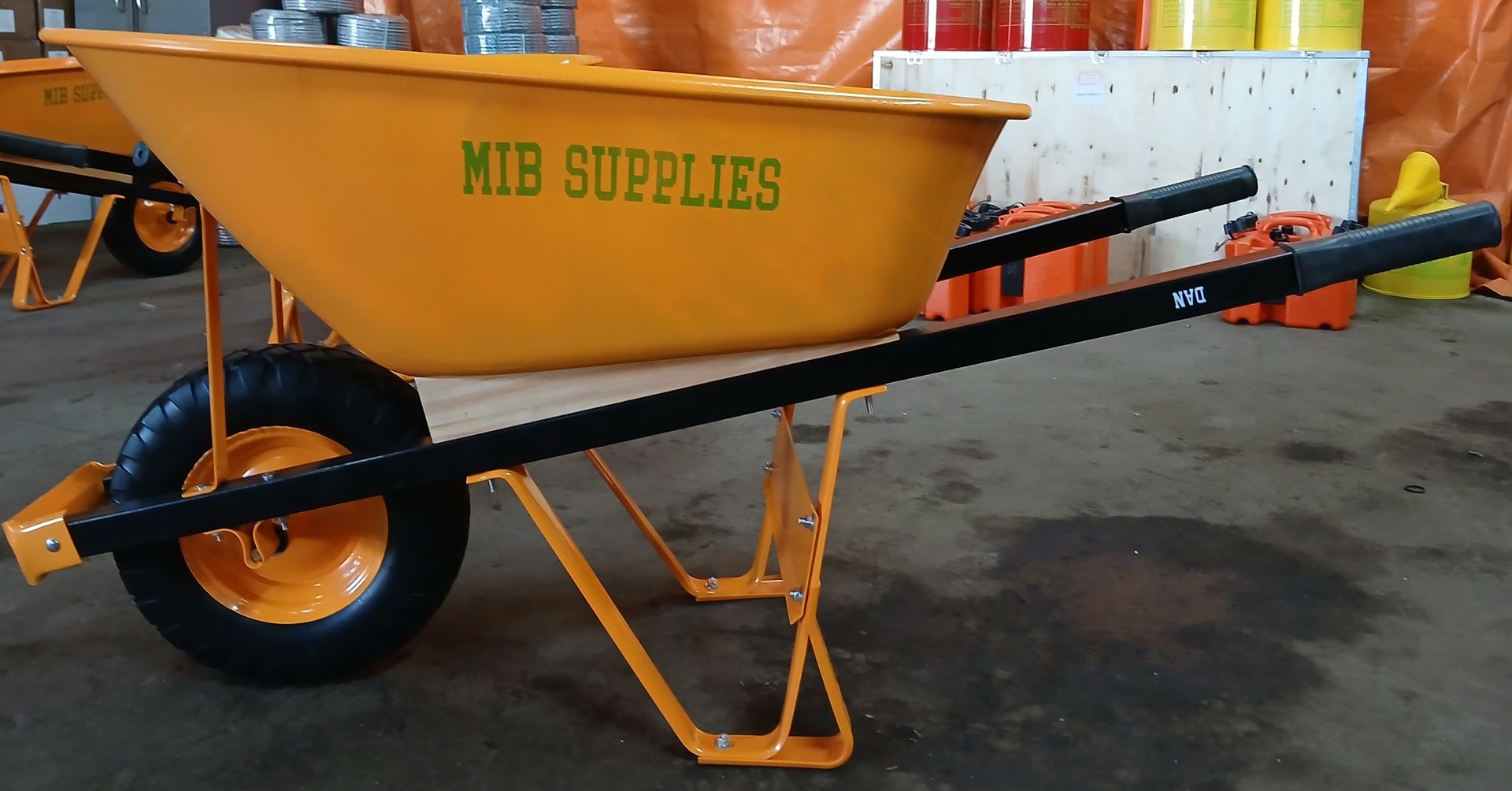 A person is cutting a tree branch with a pair of scissors.