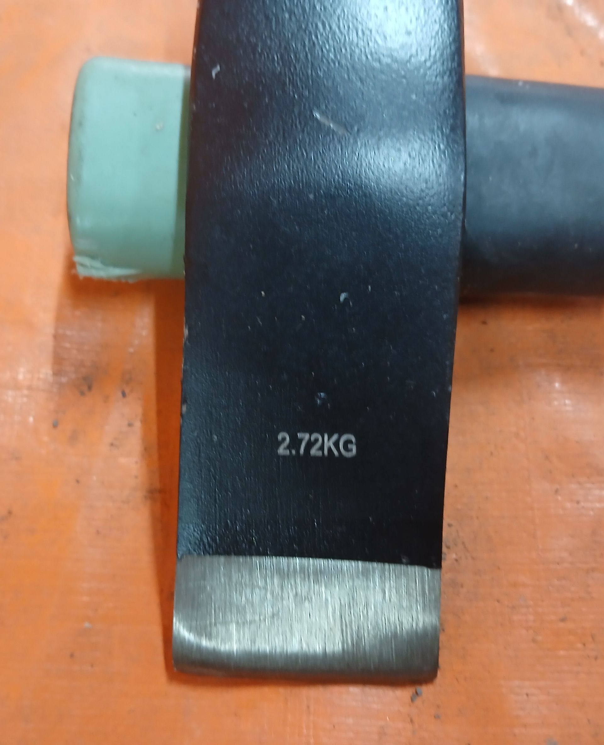 Close-up of a black sledgehammer head, with Close-up of a black sledgehammer head, with