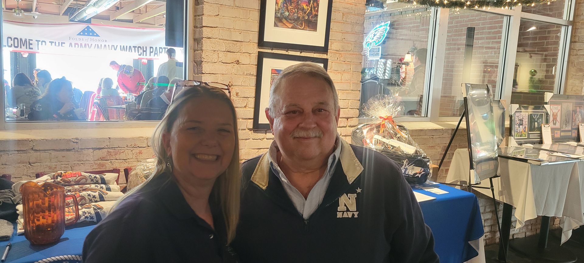 A man and a woman are posing for a picture in a restaurant
