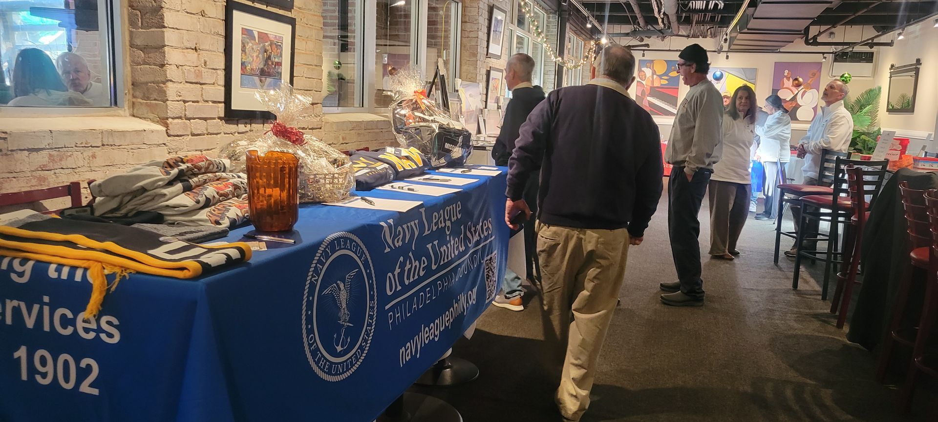 A group of people are standing around a table in a restaurant