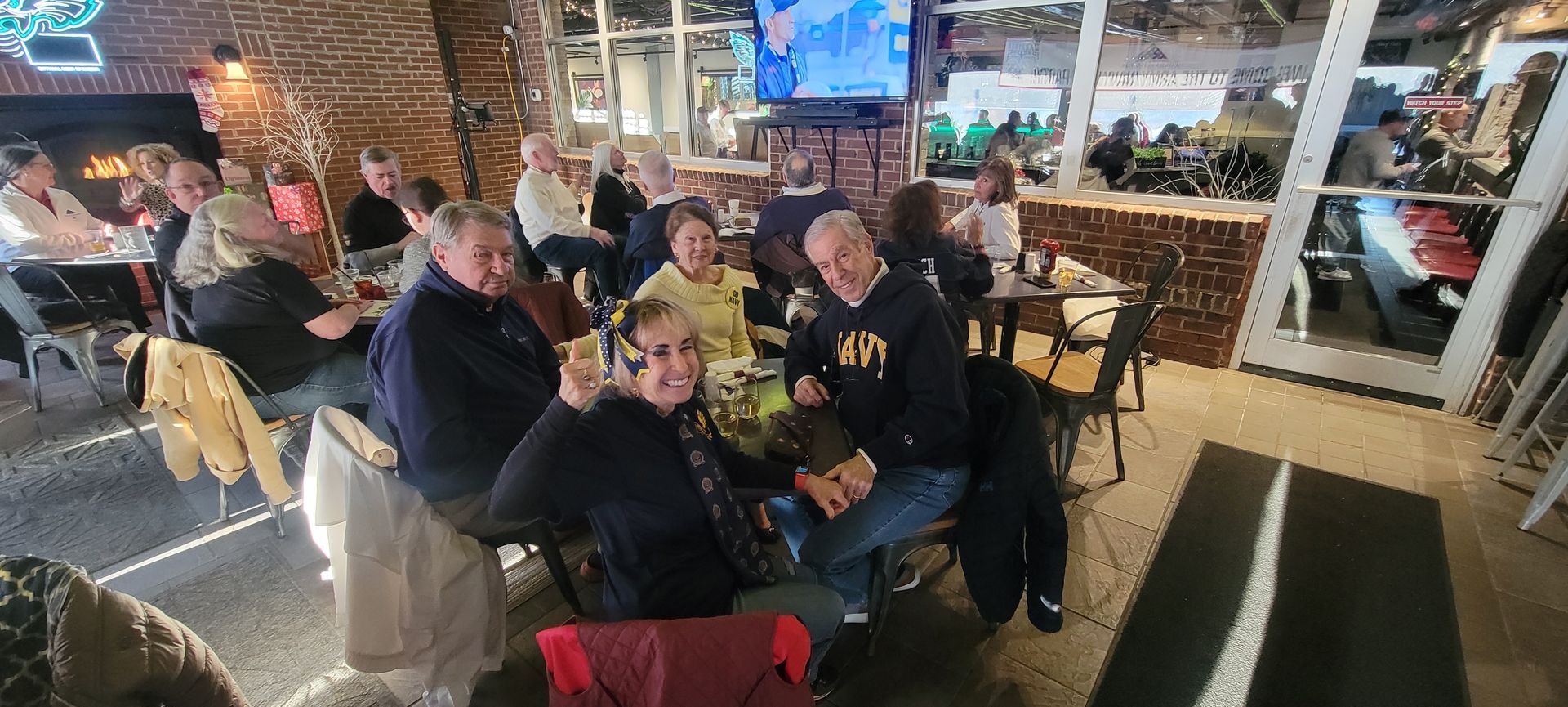 A group of people are sitting at tables in a restaurant