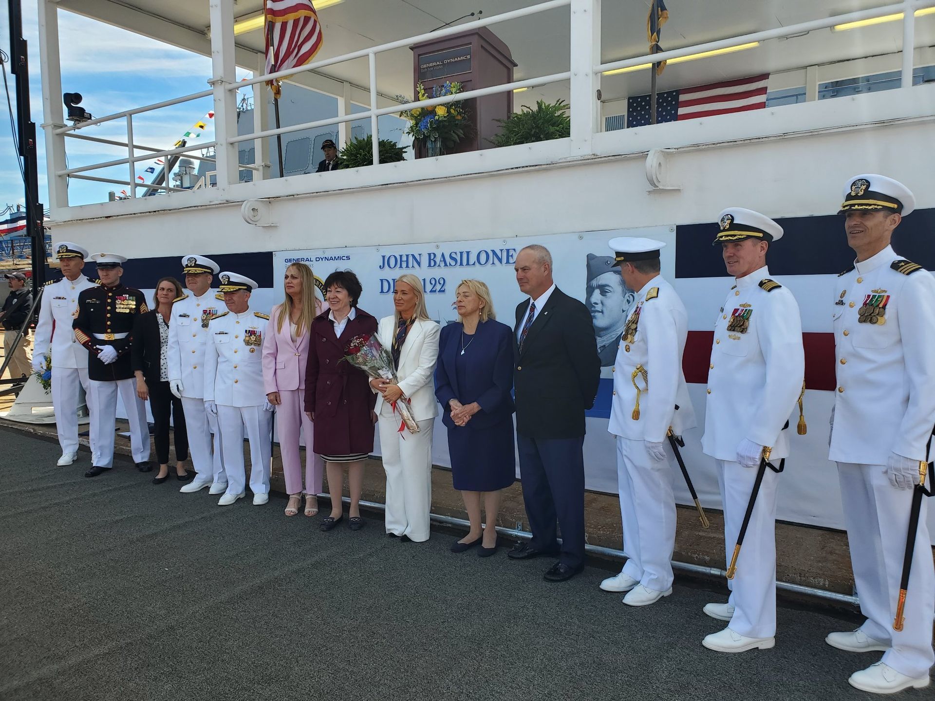 A group of people standing in front of a sign that says james band come