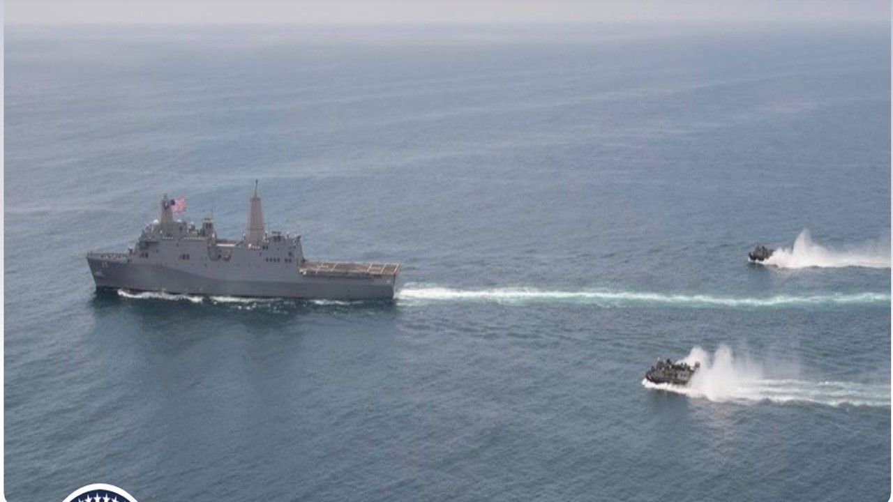 A Large Ship Is Being Towed by A Smaller Ship in The Ocean