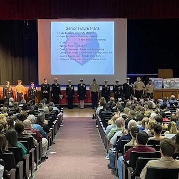 A group of people are watching a presentation about senior future plans
