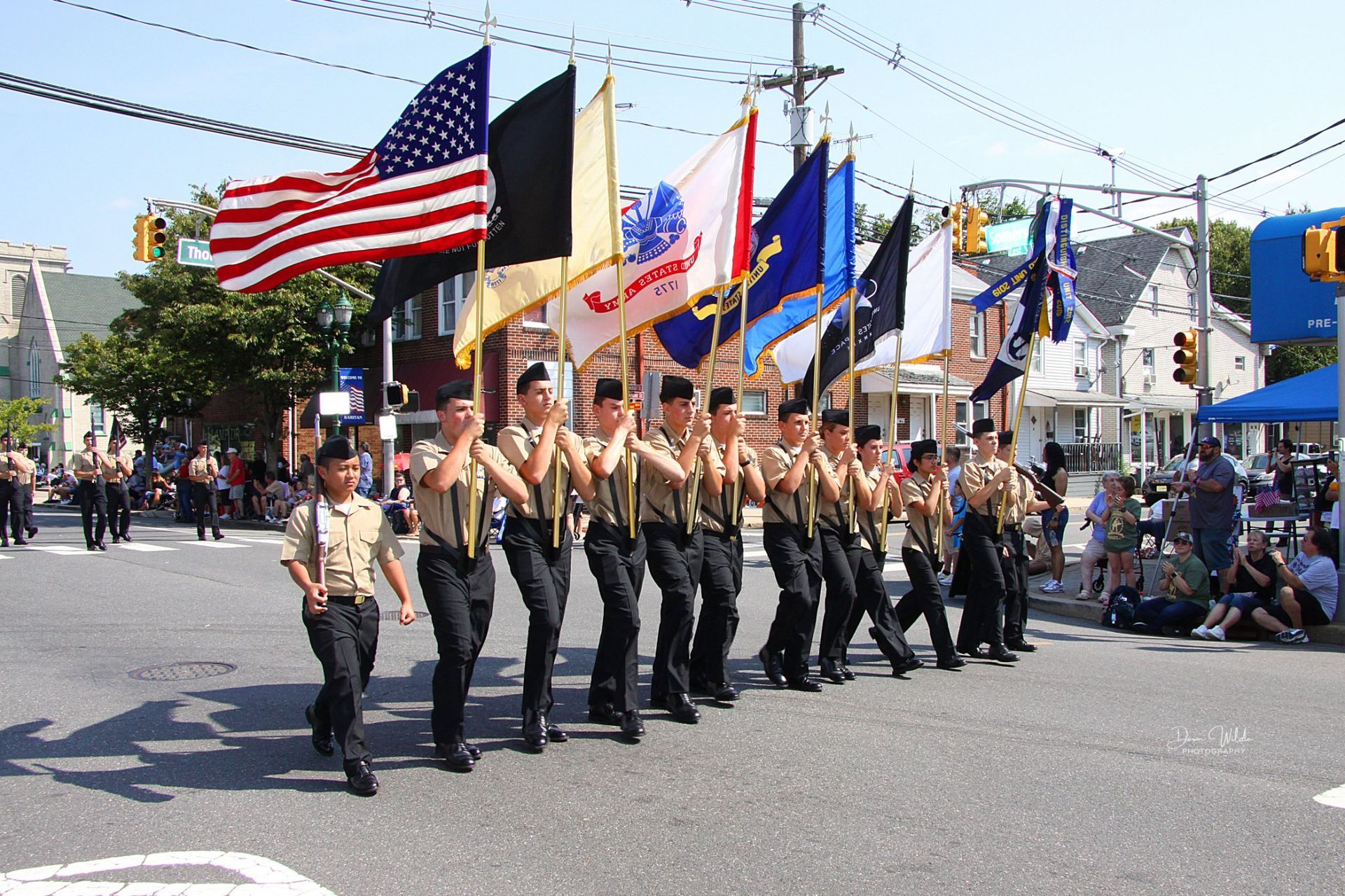 A group of people marching down a street holding flags