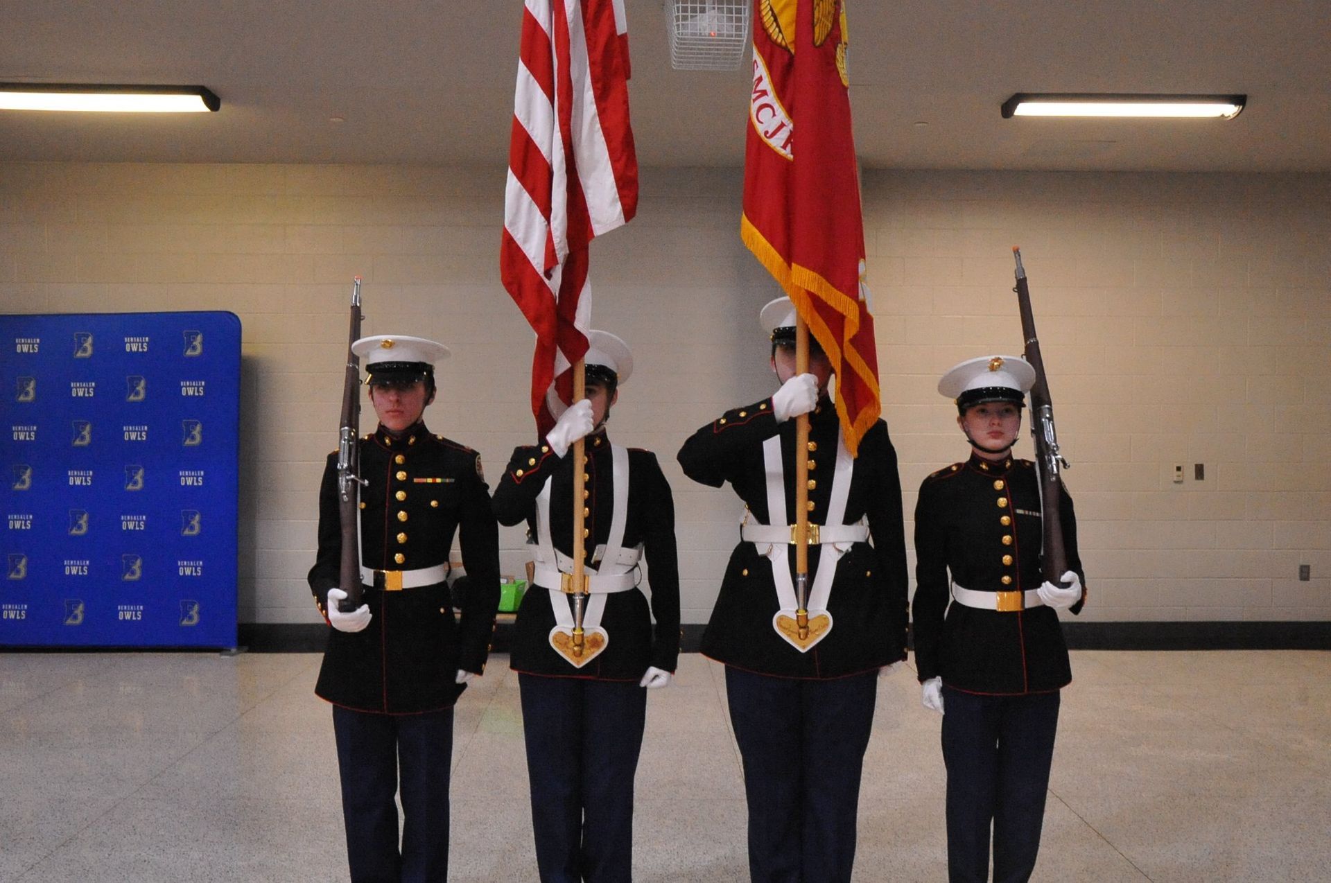 A group of people in military uniforms holding flags