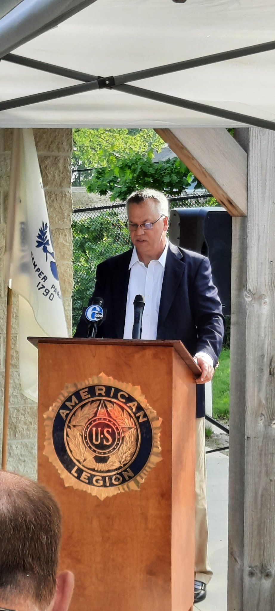 A man is standing at a podium giving a speech.