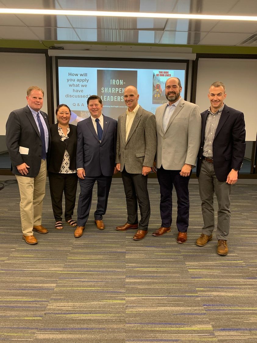 A group of people are posing for a picture in a room.