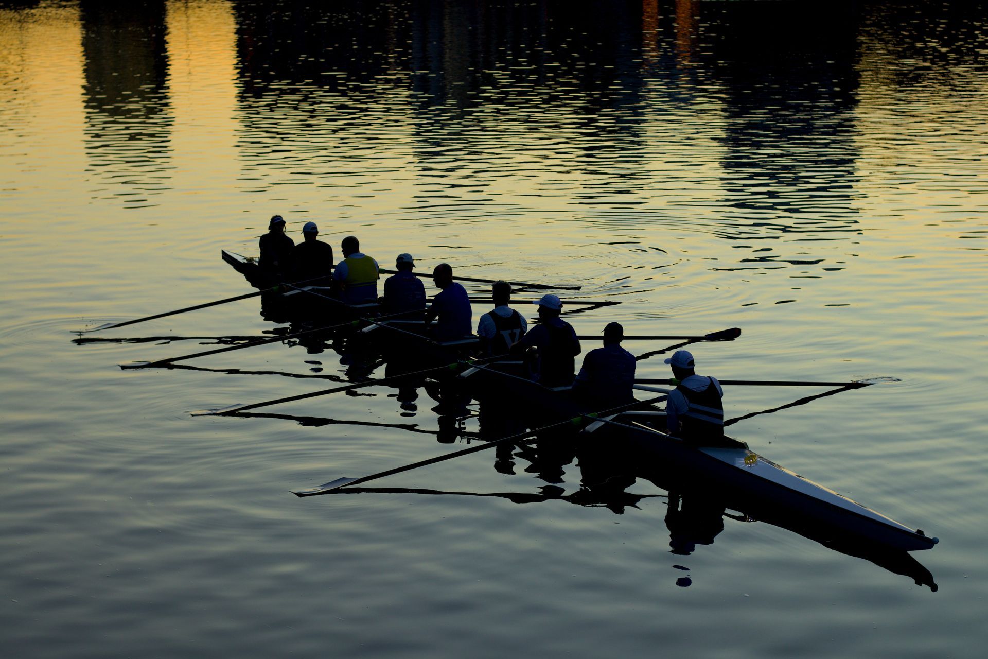 A group of people are rowing a boat in the water