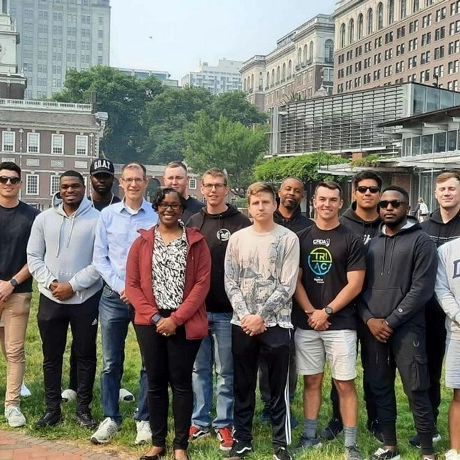 A group of people are posing for a picture in front of a building