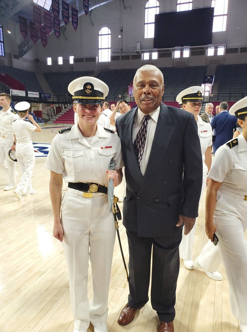 A man and a woman in military uniforms are posing for a picture