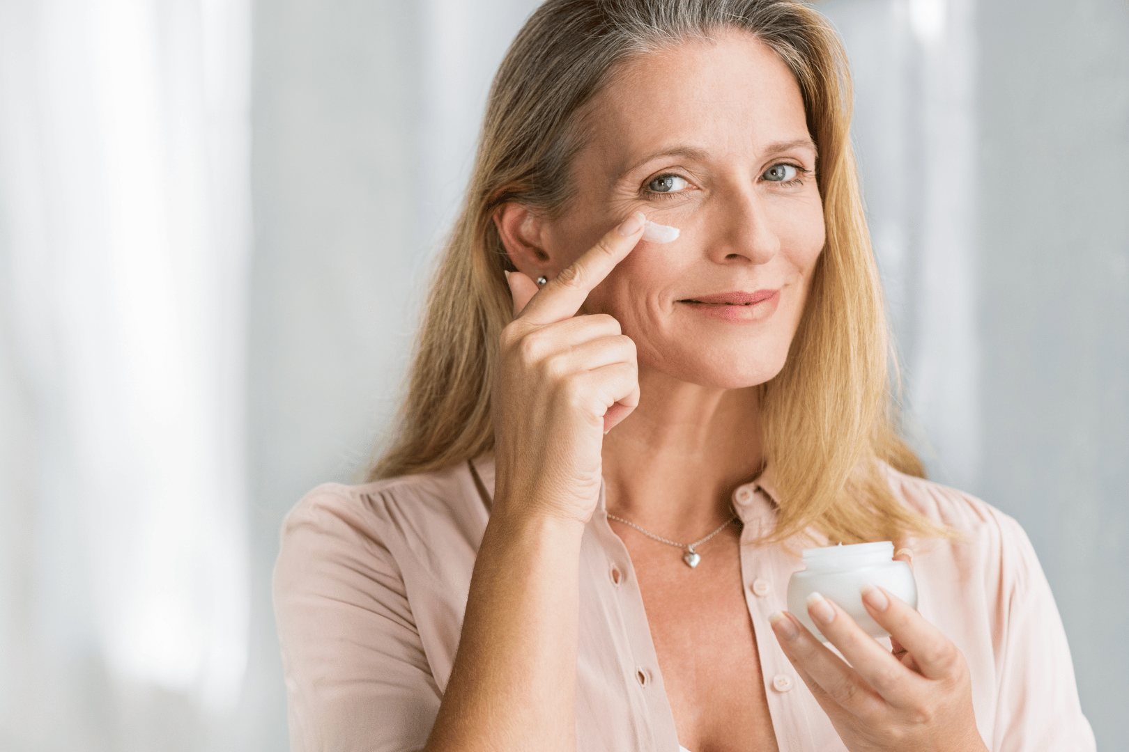 woman putting on face cream