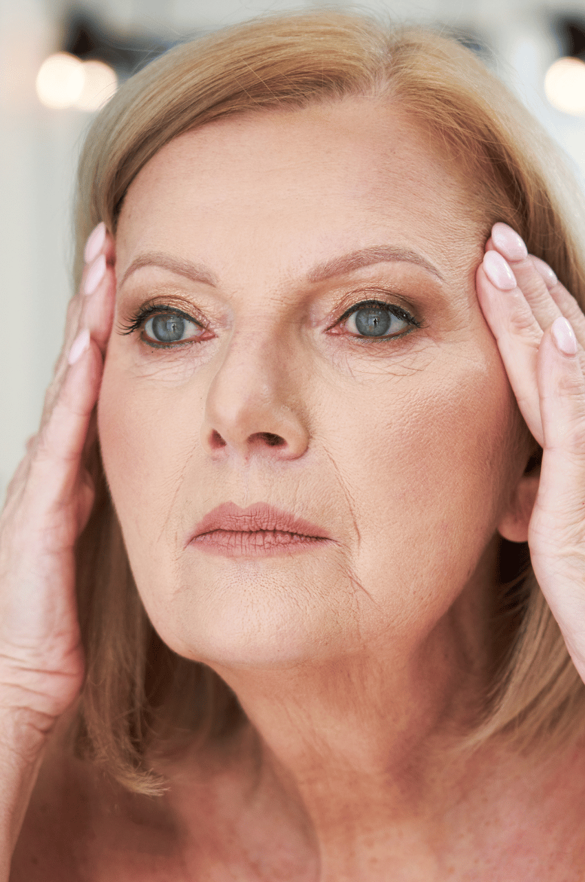 mature woman touching her face