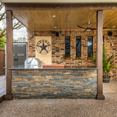 Outdoor kitchen and bar under covered patio