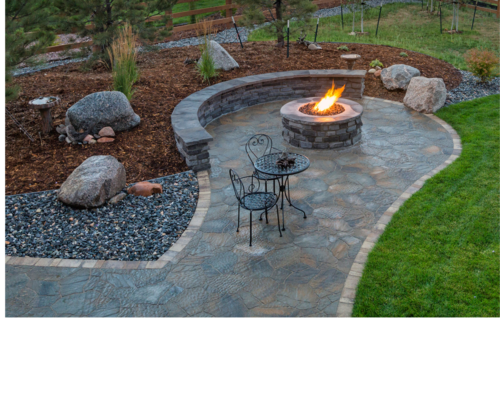 Stone patio with a flagstone fireplace feature next to an outdoor table