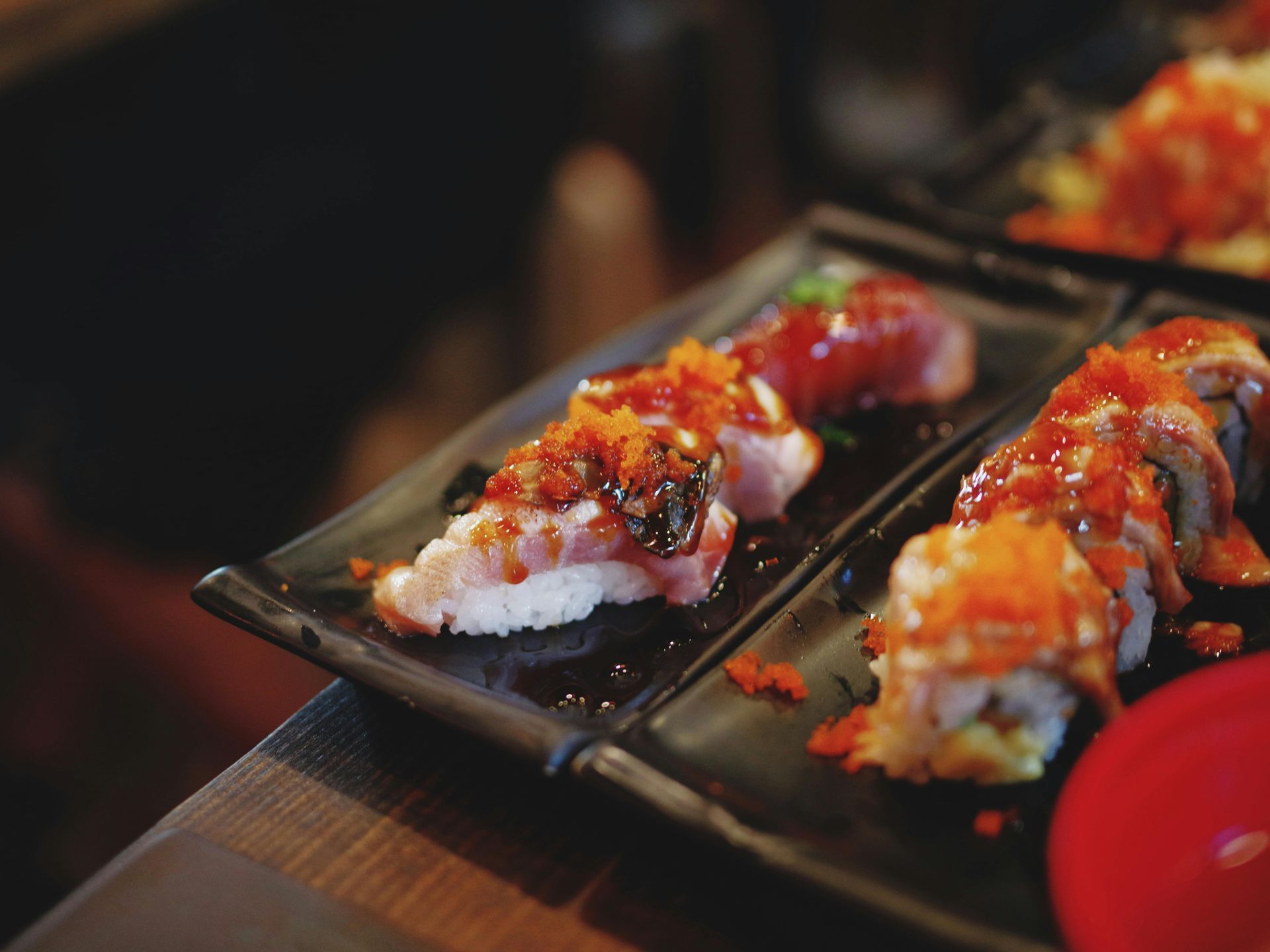 A close up of a plate of sushi on a table.