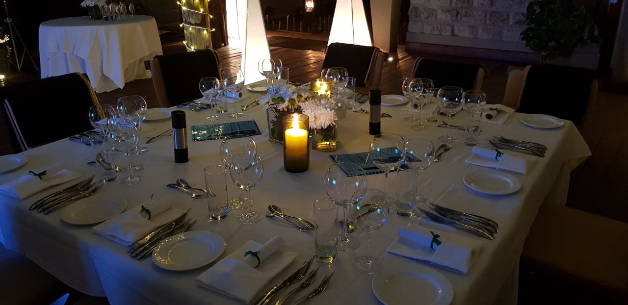 A table set for a dinner party with a candle on it.