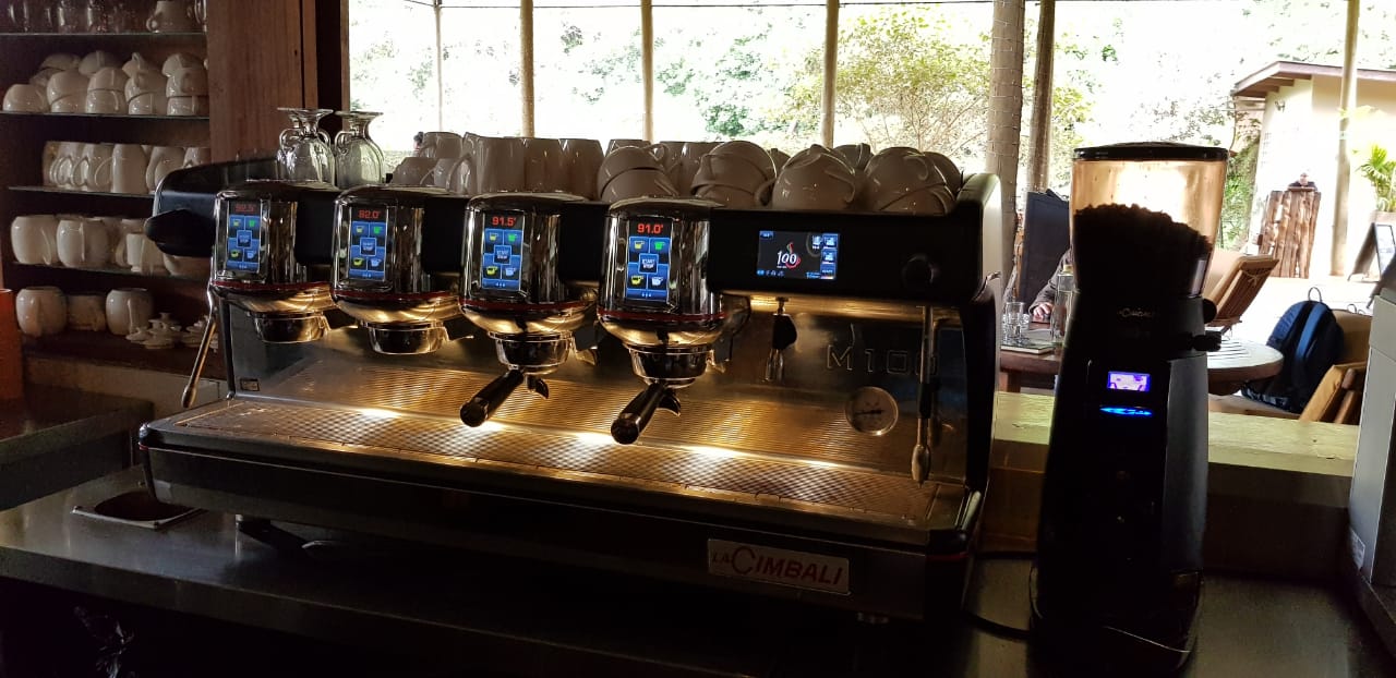 A coffee machine is sitting on a counter in a restaurant.