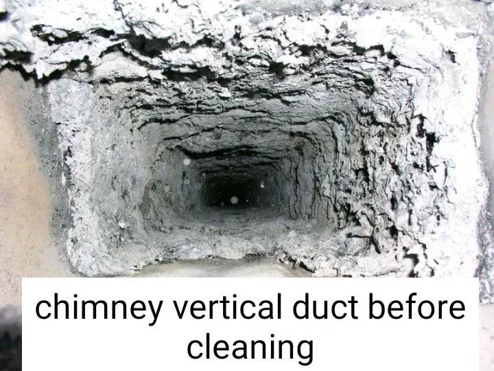 Chimney vertical duct, thick with soot, before cleaning.