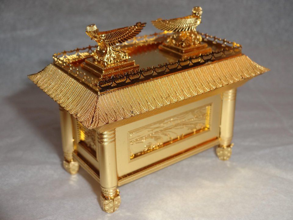 A gold box with two birds on top of it