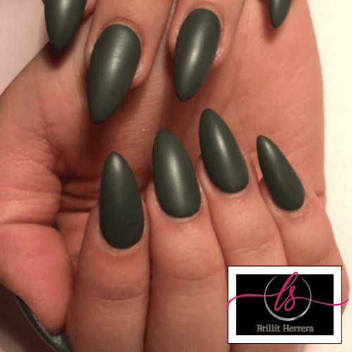 Hand with matte olive green almond-shaped nails; a nail salon logo is in the corner.