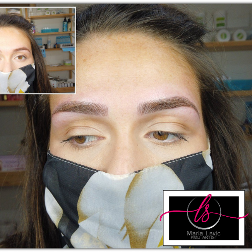 Woman with light-colored, newly-shaped eyebrows, wearing a floral face mask, set in what appears to be a salon.