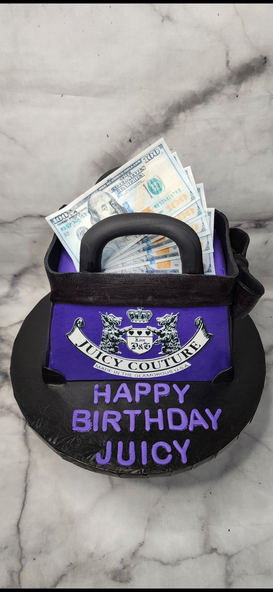 A birthday cake in the shape of a purse filled with money.