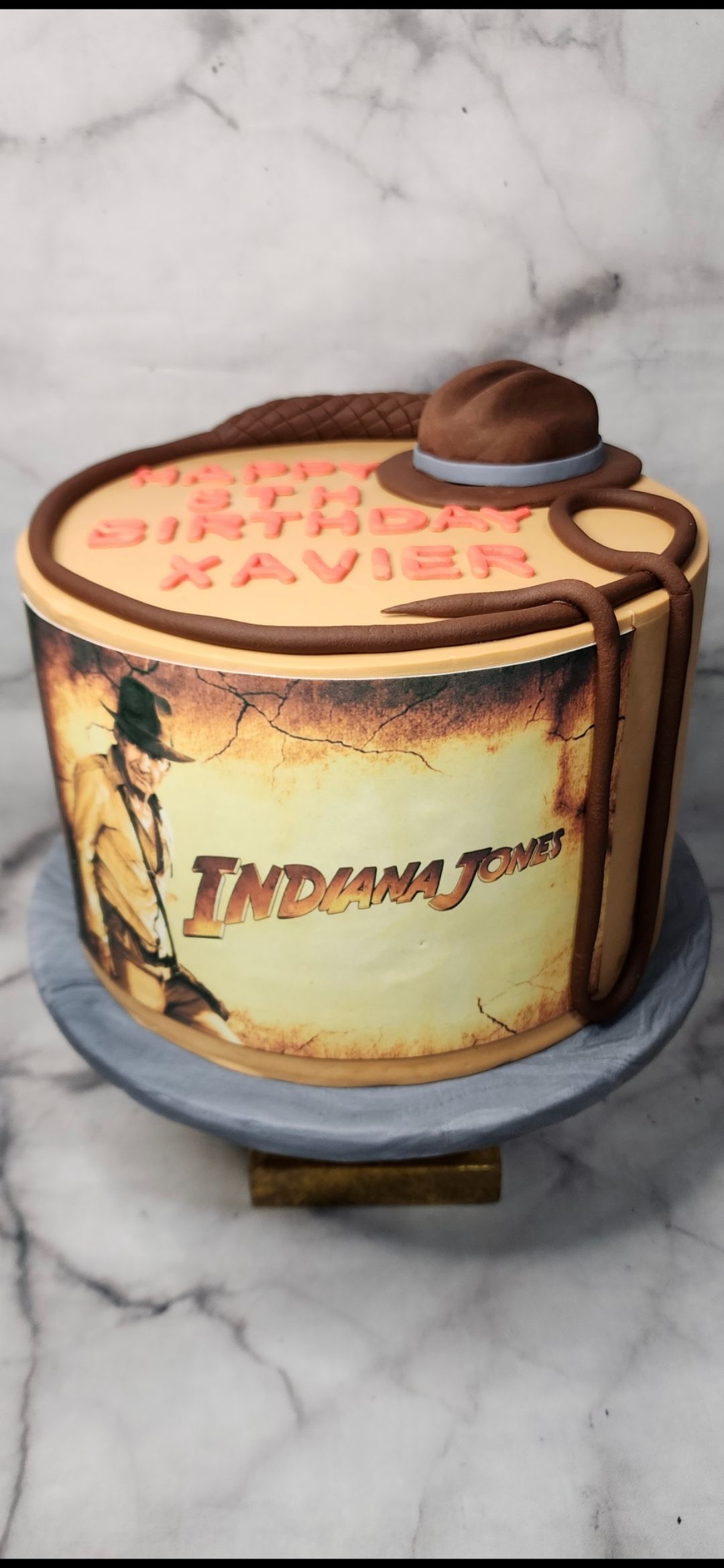 A cake with a picture of indiana jones on it