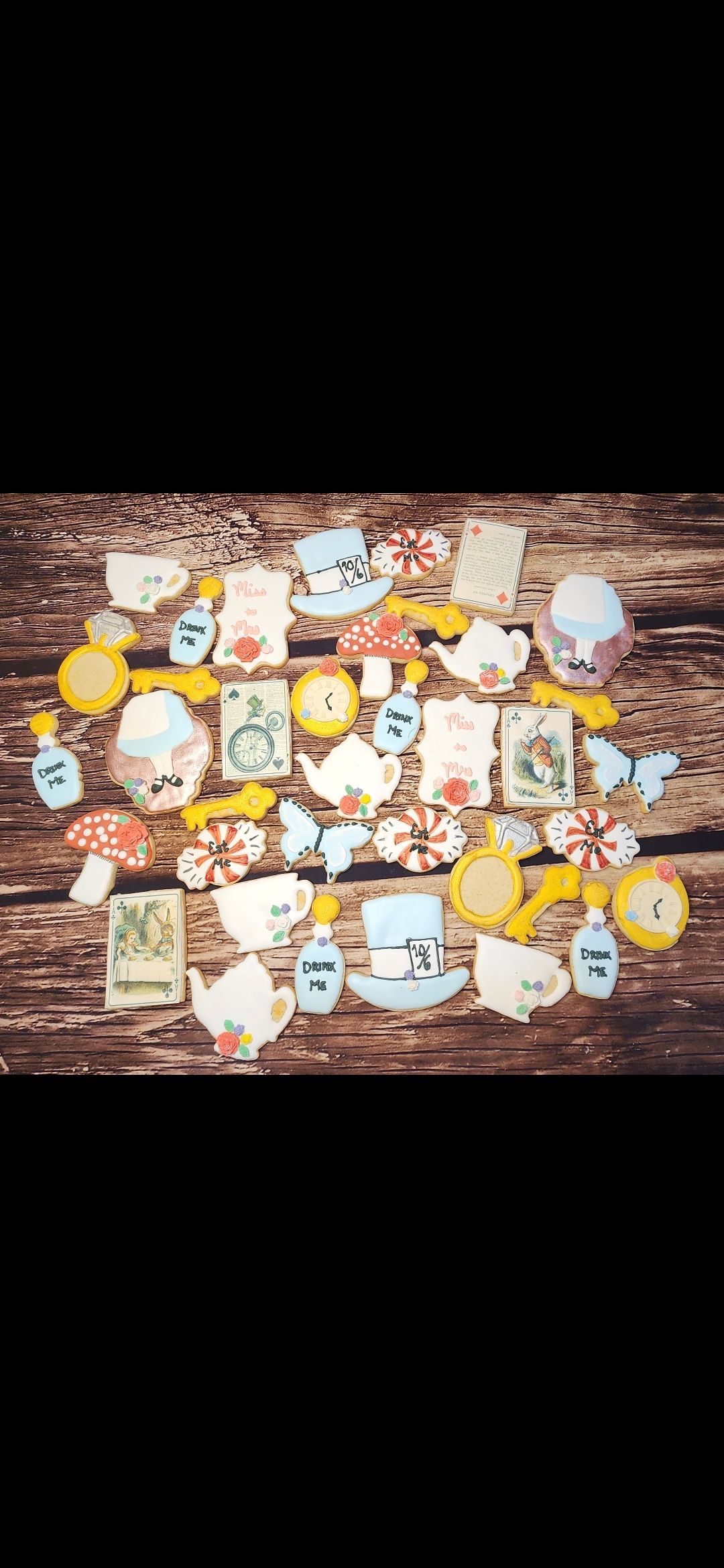 A bunch of cookies are sitting on top of a wooden table.