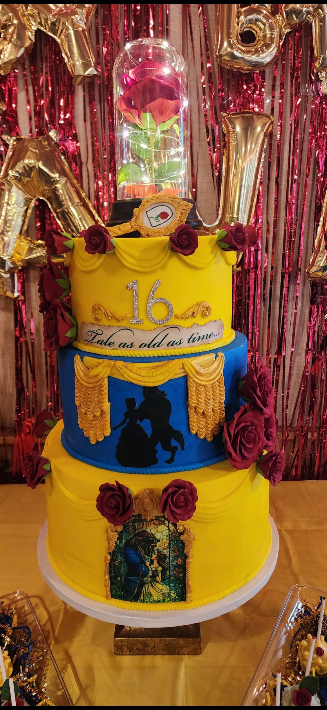 A yellow and blue cake is sitting on top of a table.