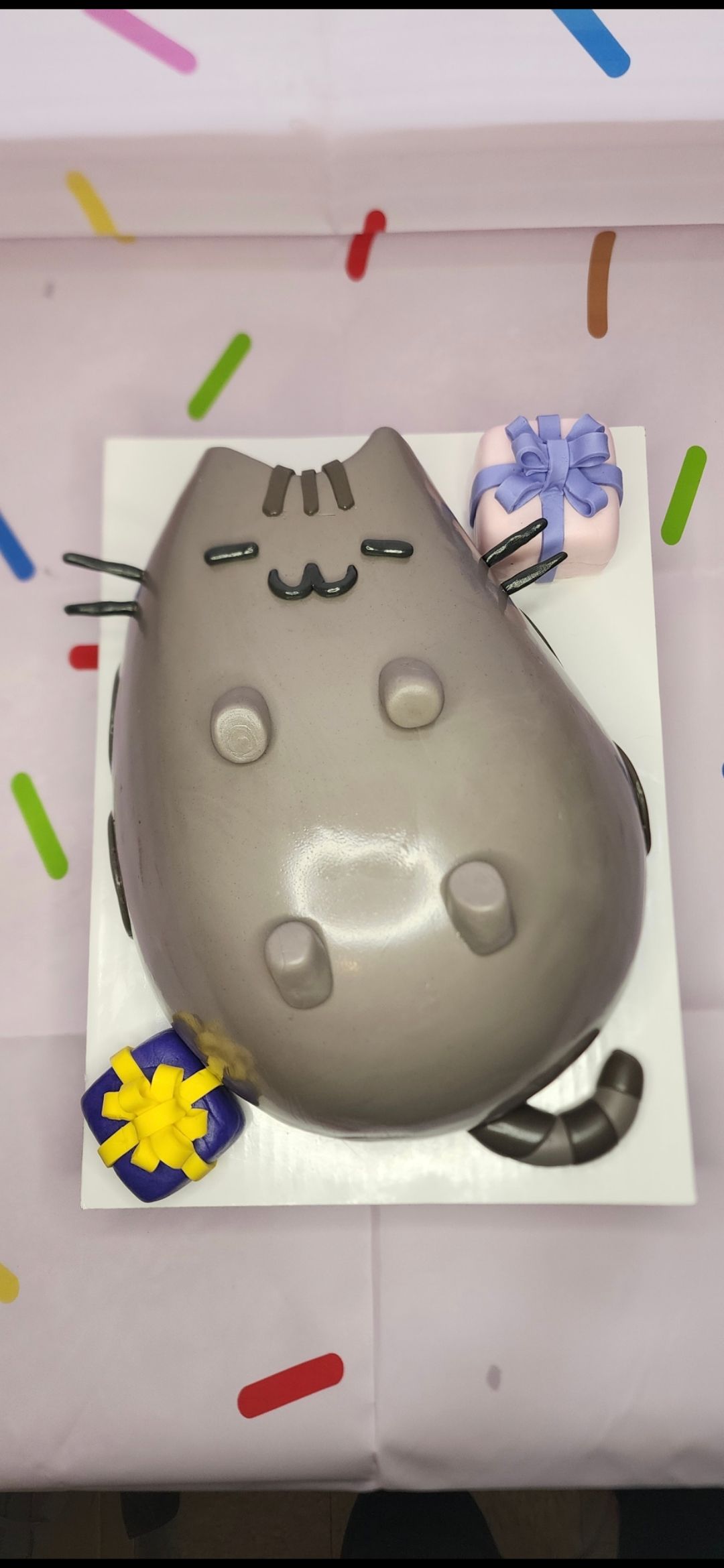 A cake in the shape of a cat on a table