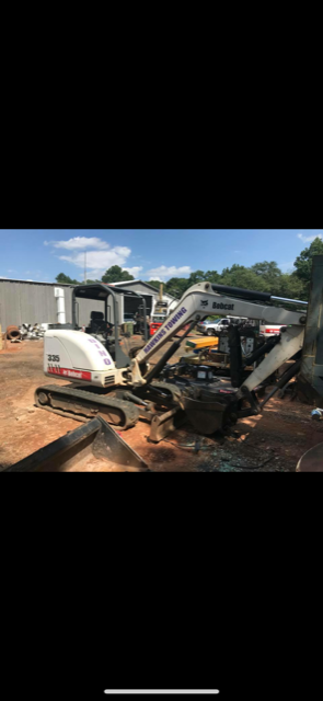 a bulldozer is sitting on top of a dirt field .