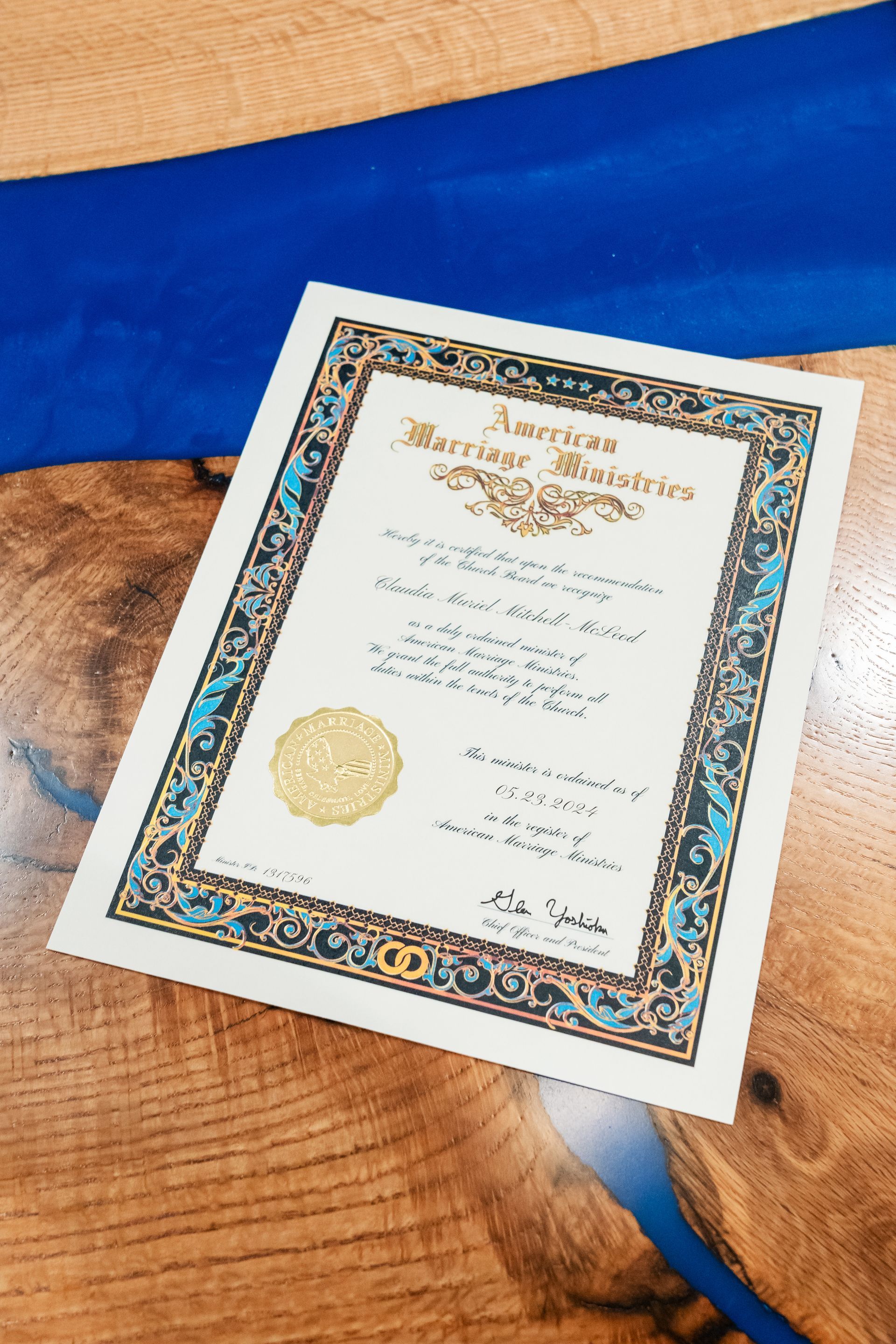 An american marriage certificate is sitting on a wooden table.