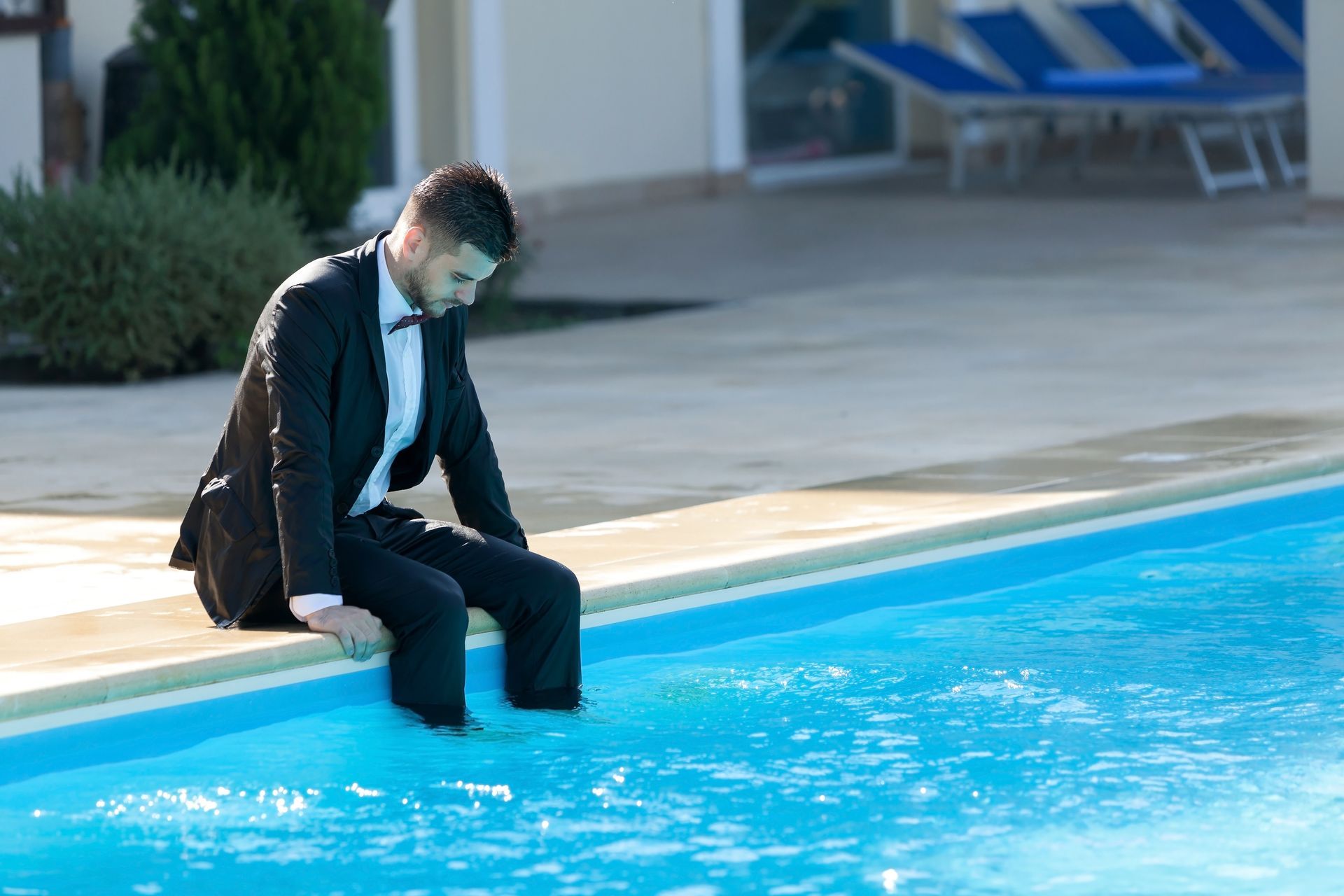 Wedding guest alone outside after reception with somber expression
