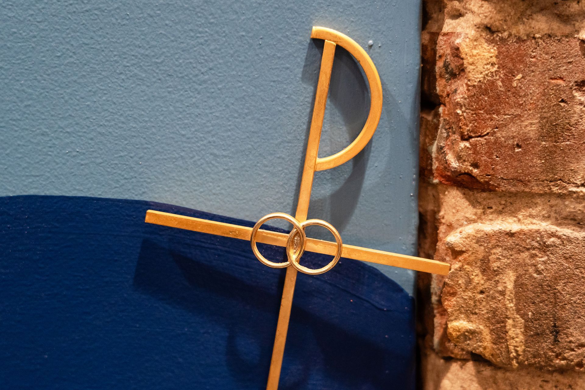 A long wooden table with plates , silverware , candles and a menu on it.
