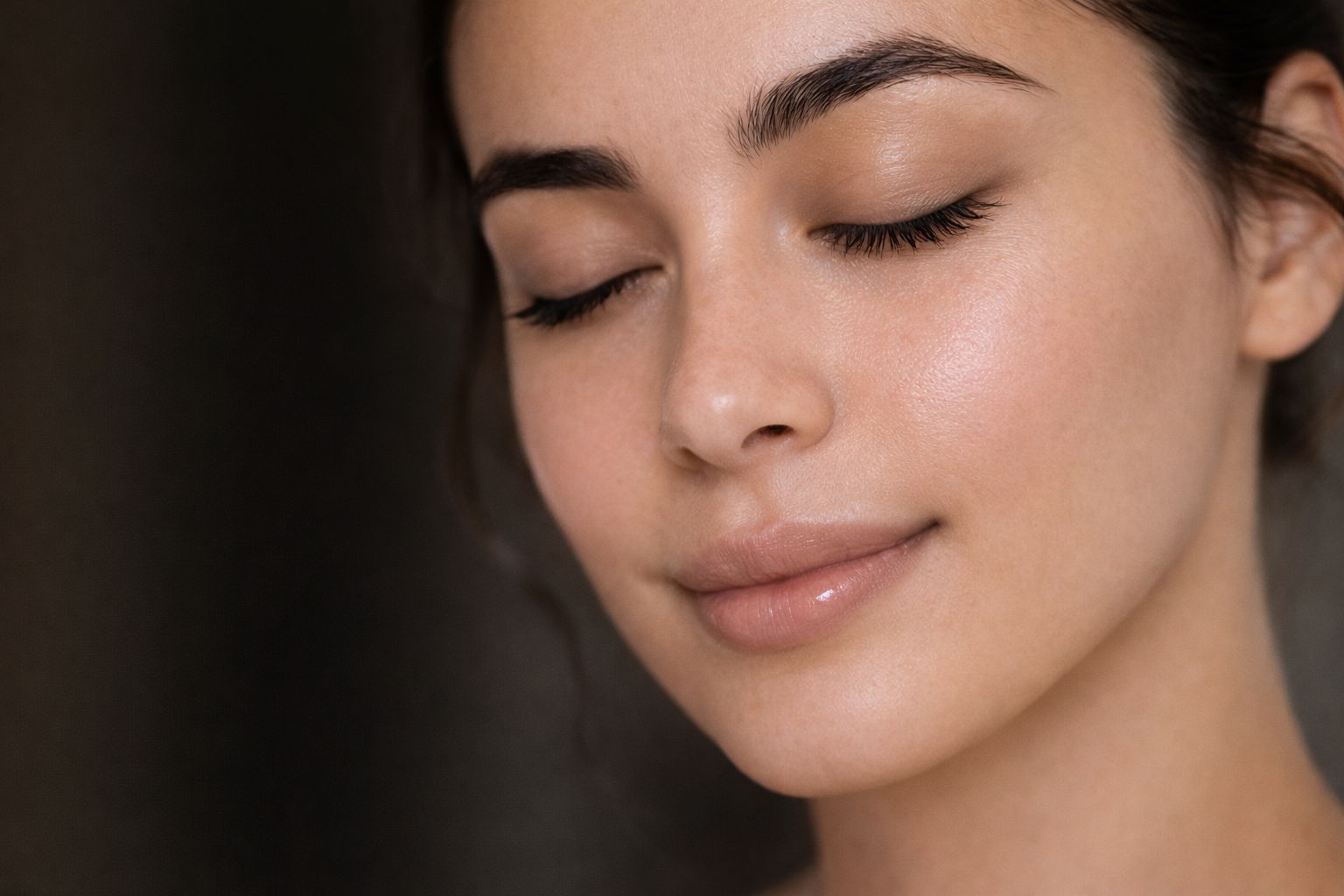 Woman receiving a professional facial treatment with advanced skincare device at a medical spa.
