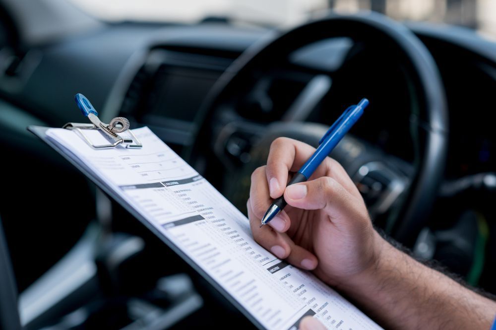 A Woman Is Holding A Magnifying Glass Over A Piece Of Paper — Ballina Rego & Mechanical Centre In Ballina, NSW