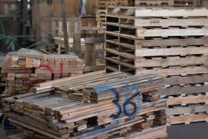 A warehouse filled with lots of wooden boxes and pallets