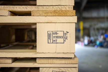 A warehouse filled with lots of wooden boxes and pallets
