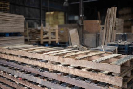 A warehouse filled with lots of wooden boxes and pallets