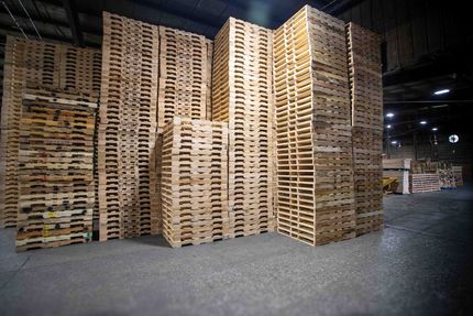 A warehouse filled with lots of wooden boxes and pallets