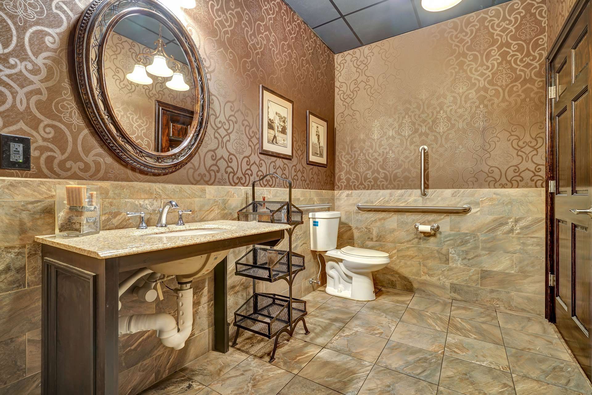 A bathroom with a sink, toilet and mirror