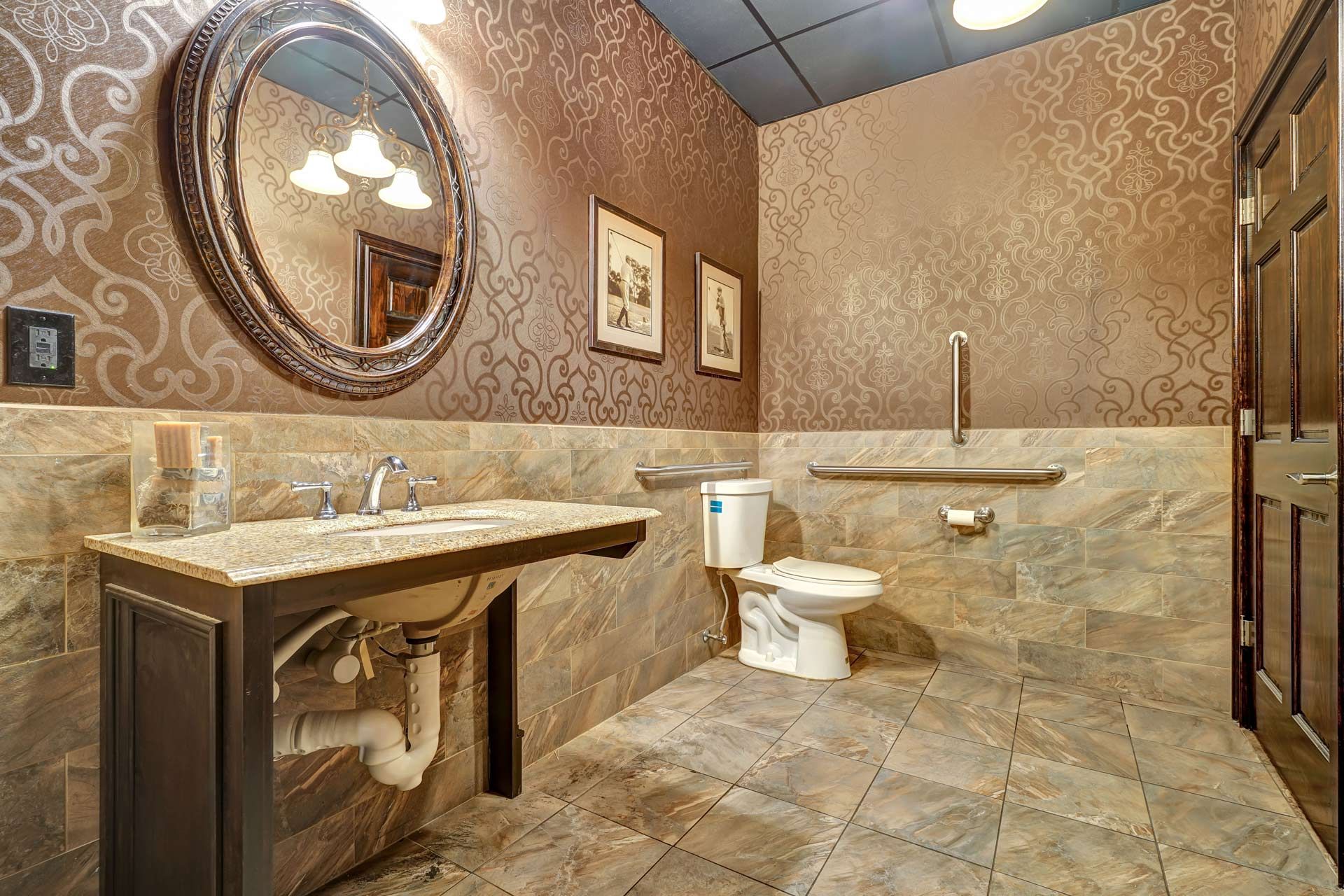 A bathroom with a sink, toilet and mirror