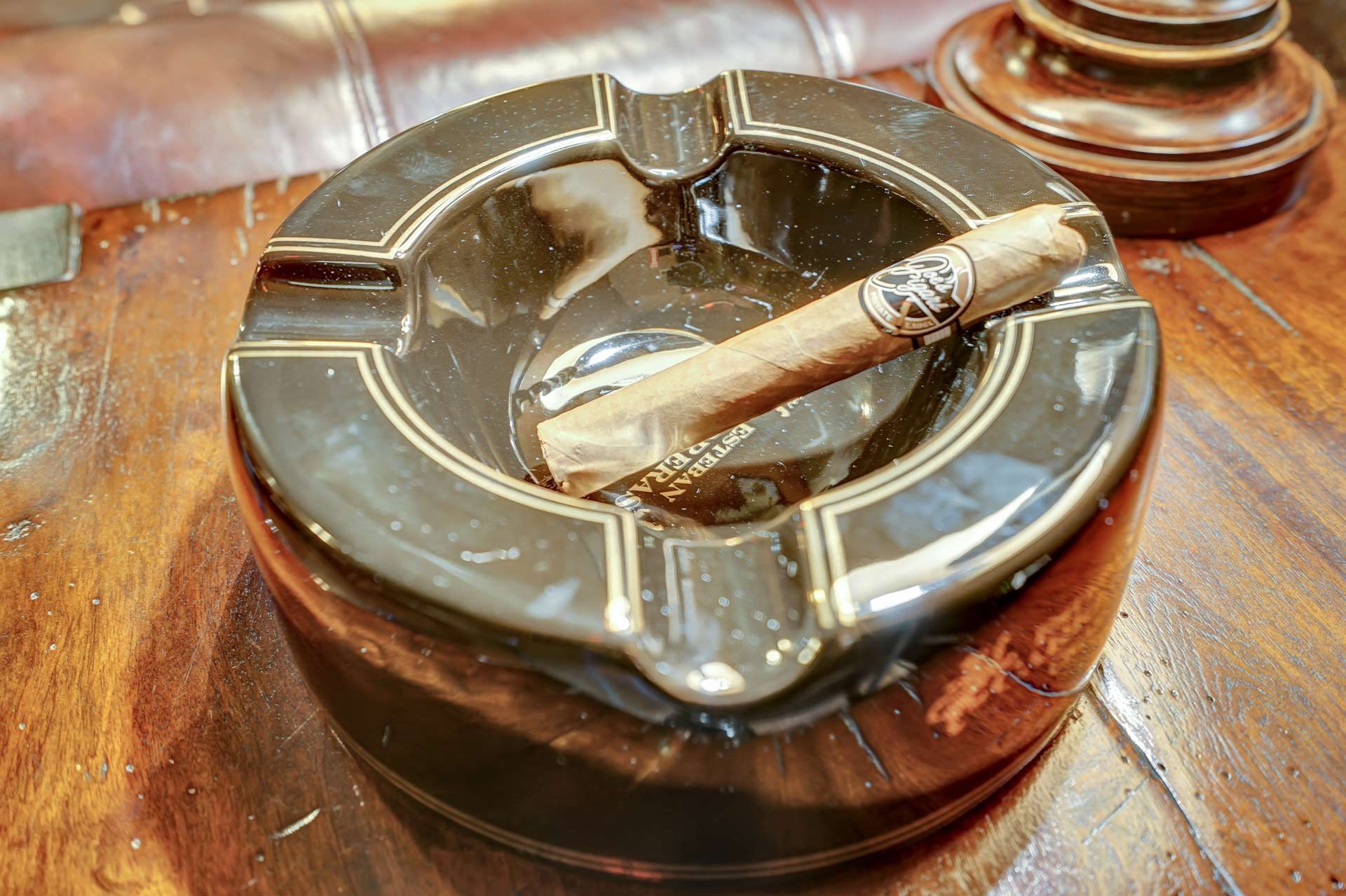 Cigar resting on a vintage ashtray