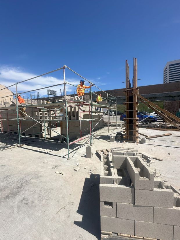 Scaffolding on a brick building, providing access to windows.