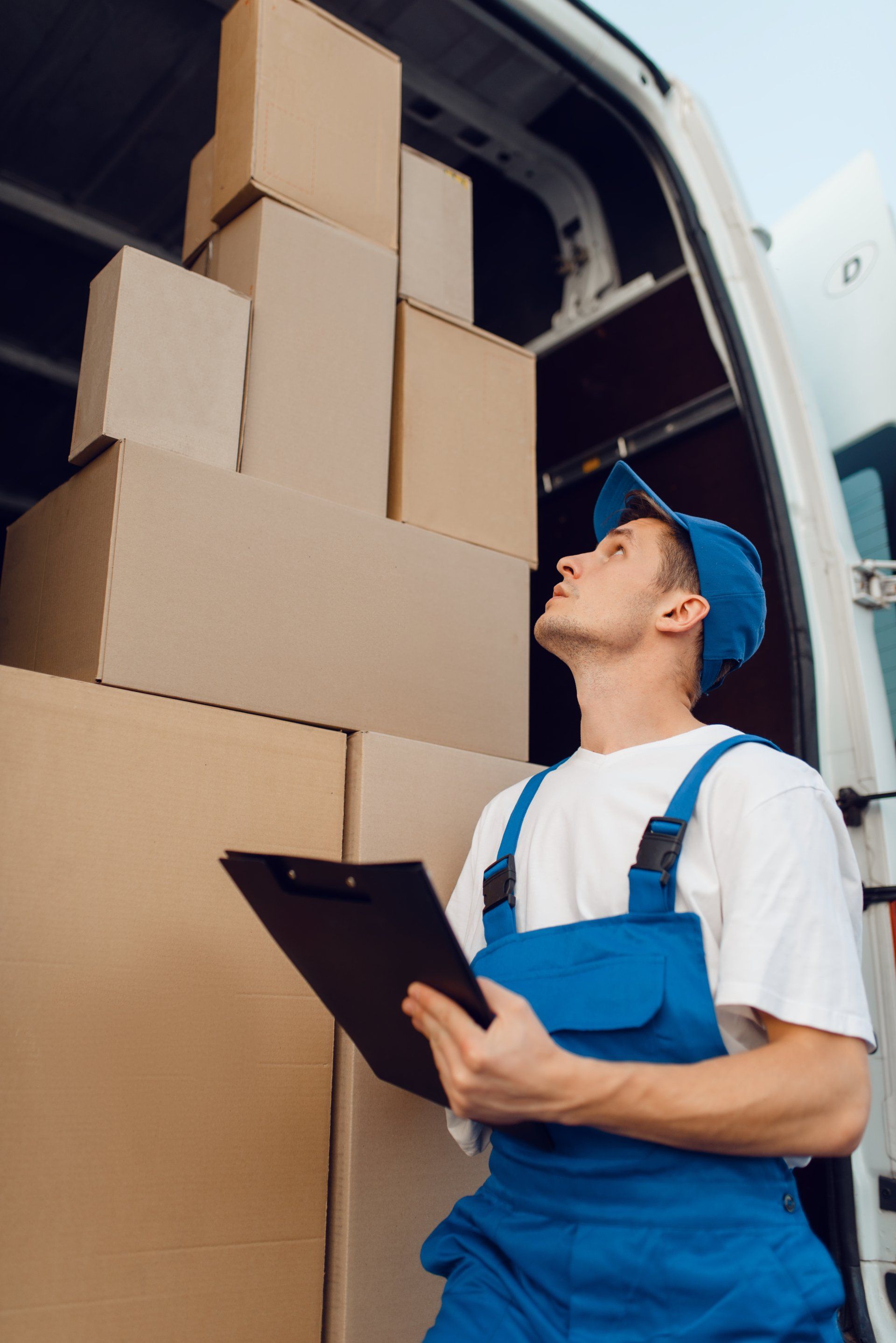 delivery man with parcel boxes in a truck