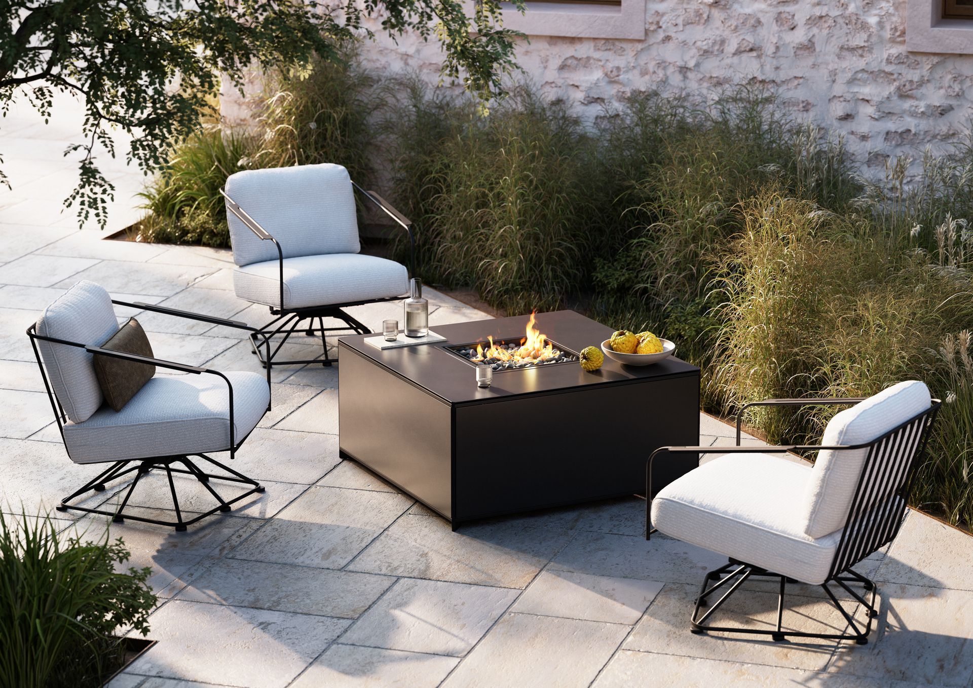 Outdoor seating area with white chairs around a black fire pit.