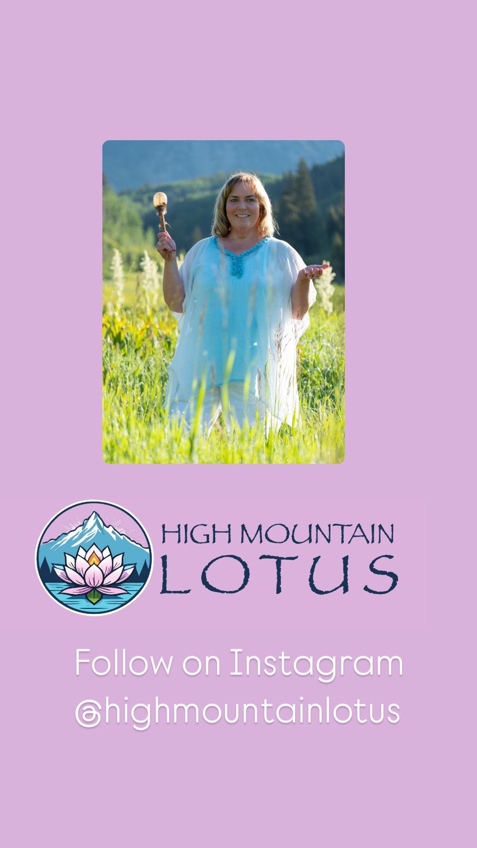 A woman in a blue dress is standing in a field holding a flower.